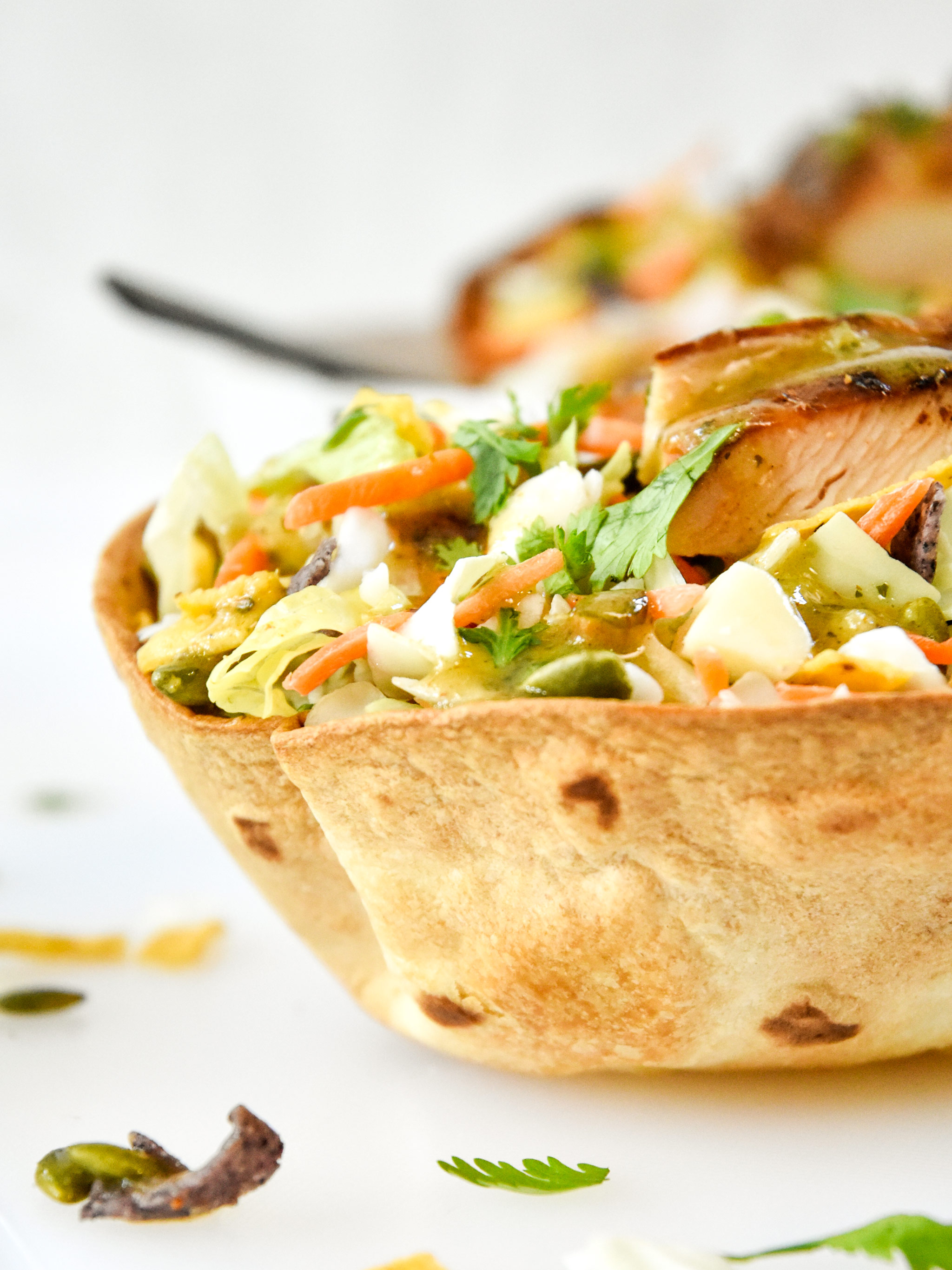 delicious taco salad with chicken in an air fryer flour tortilla bowl.