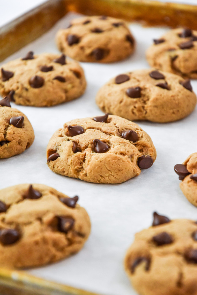 baked chocolate chip pancake mix cookies on a half sheet pan.